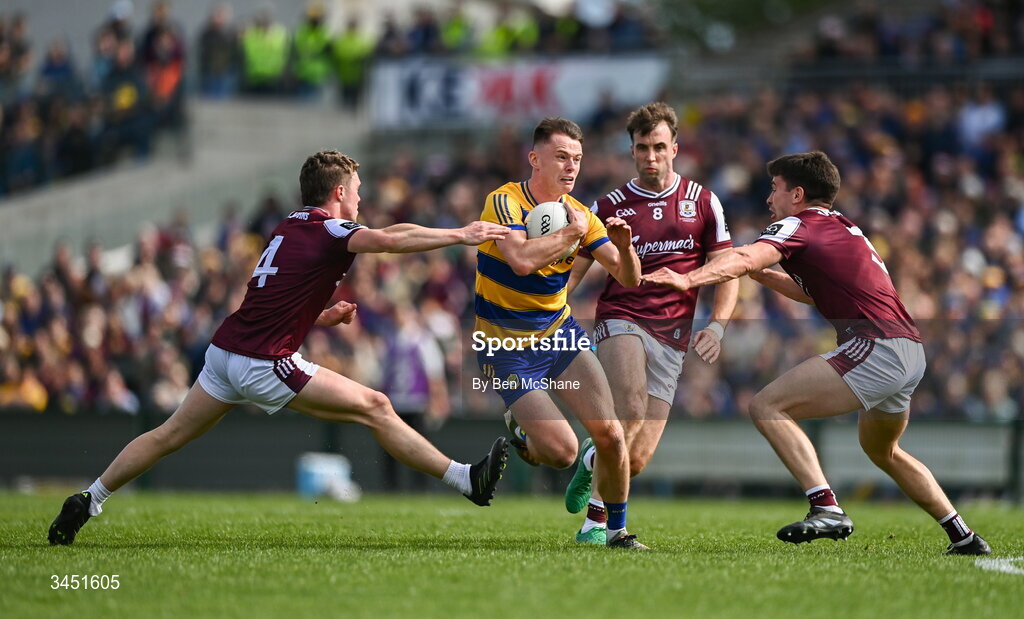 10 May 2026; Darragh Heneghan of Roscommon is tackled by Galway players, from left, Jack Glynn, Paul Conroy and Seán Kelly during the Connacht GAA Football Senior Championship final match between Roscommon and Galway at King & Moffatt Dr Hyde Park in Roscommon. Photo by Ben McShane/Sportsfile