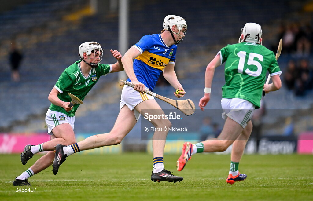 15 May 2026; Oisín Kennedy of Tipperary in action against Eamon O'Sullivan and Daire Long, right, of Limerick during the Electric Ireland Munster GAA Minor Hurling Championship final match between Tipperary and Limerick at FBD Semple Stadium in Thurles, Tipperary. Photo by Piaras Ó Mídheach/Sportsfile