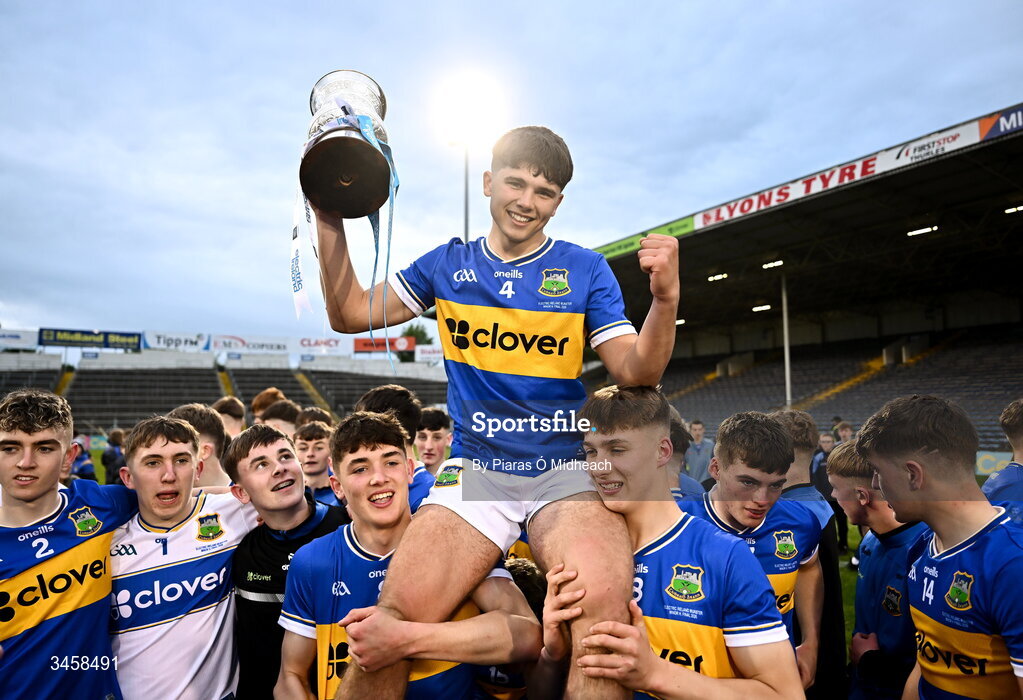 15 May 2026; Tipperary captain Conor Collins is held aloft by team-mates after victory in the Electric Ireland Munster GAA Minor Hurling Championship final match between Tipperary and Limerick at FBD Semple Stadium in Thurles, Tipperary. Photo by Piaras Ó Mídheach/Sportsfile