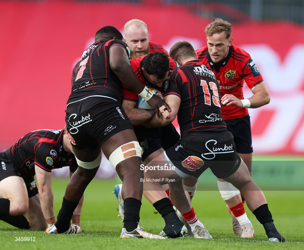 16 May 2026; Andrew Smith of Munster is tackled by SJ Kotze, left, and Henco van Wyk of Lions during the United Rugby Championship match between Munster and Lions at Thomond Park in Limerick. Photo by Michael P Ryan/Sportsfile