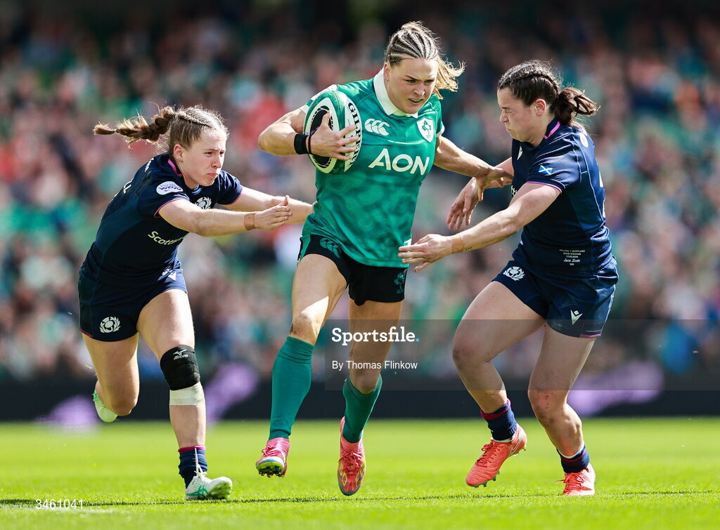 17 May 2026; Béibhinn Parsons of Ireland is tackled by Shona Campbell, left, and Rhea Clarke of Scotland during the Women's 6 Nations Rugby Championship match between Ireland and Scotland at the Aviva Stadium in Dublin. Photo by Thomas Flinkow/Sportsfile