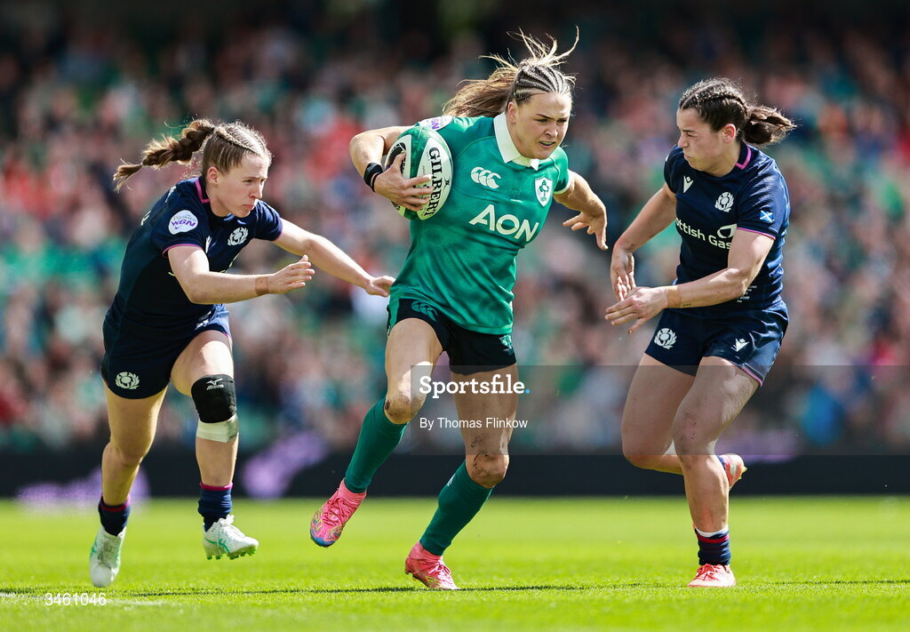 17 May 2026; Béibhinn Parsons of Ireland is tackled by Shona Campbell, left, and Rhea Clarke of Scotland during the Women's 6 Nations Rugby Championship match between Ireland and Scotland at the Aviva Stadium in Dublin. Photo by Thomas Flinkow/Sportsfile