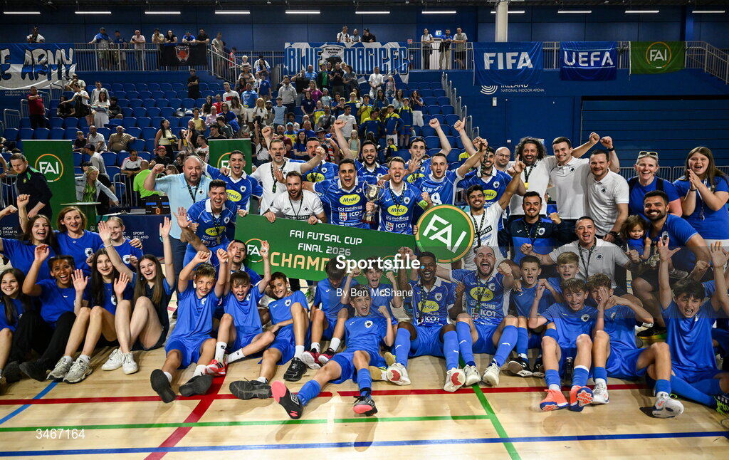 24 May 2026; Blue Magic players and staff celebrate with the cup after the FAI Futsal Cup final match between Leinster Futsal and Blue Magic at the National Indoor Arena in Abbotstown, Dublin. Photo by Ben McShane/Sportsfile