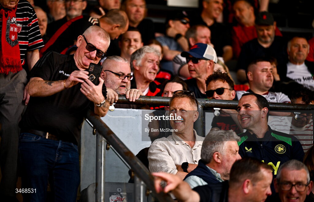 25 May 2026; Republic of Ireland head coach Heimir Hallgrimsson, centre, and assistant coach John O'Shea take a selfie with Bohemians supporter Davy Keogh before the SSE Airtricity Men’s Premier Division match between Bohemians and Shamrock Rovers at Dalymount Park in Dublin. Photo by Ben McShane/Sportsfile