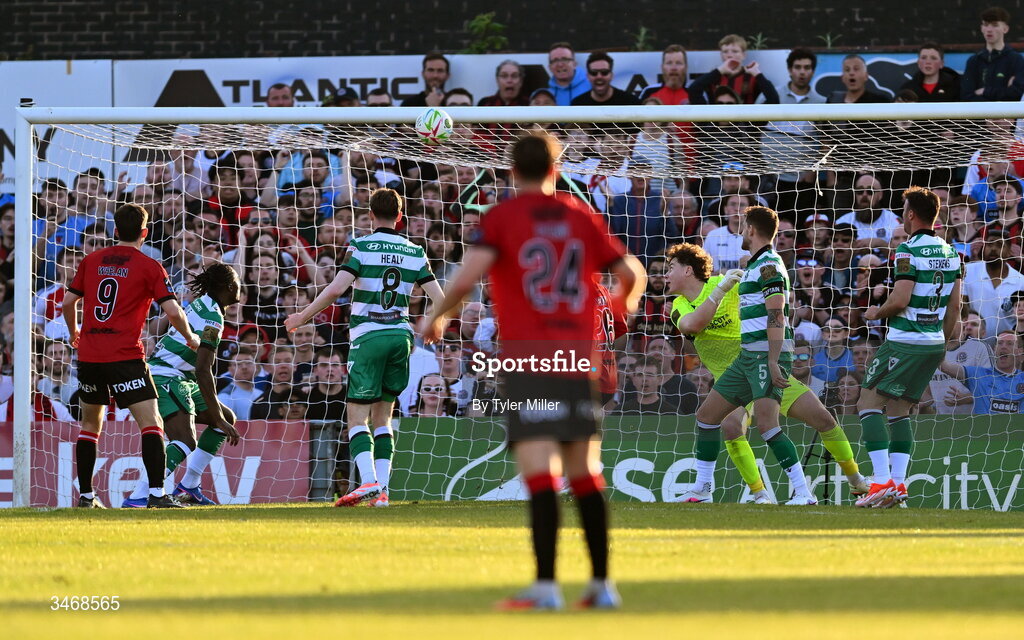 25 May 2026; Ross Tierney of Bohemians, hidden, shoots to score his side's first goal as Shamrock Rovers goalkeeper Ed McGinty attempts to make a save during the SSE Airtricity Men’s Premier Division match between Bohemians and Shamrock Rovers at Dalymount Park in Dublin. Photo by Tyler Miller/Sportsfile