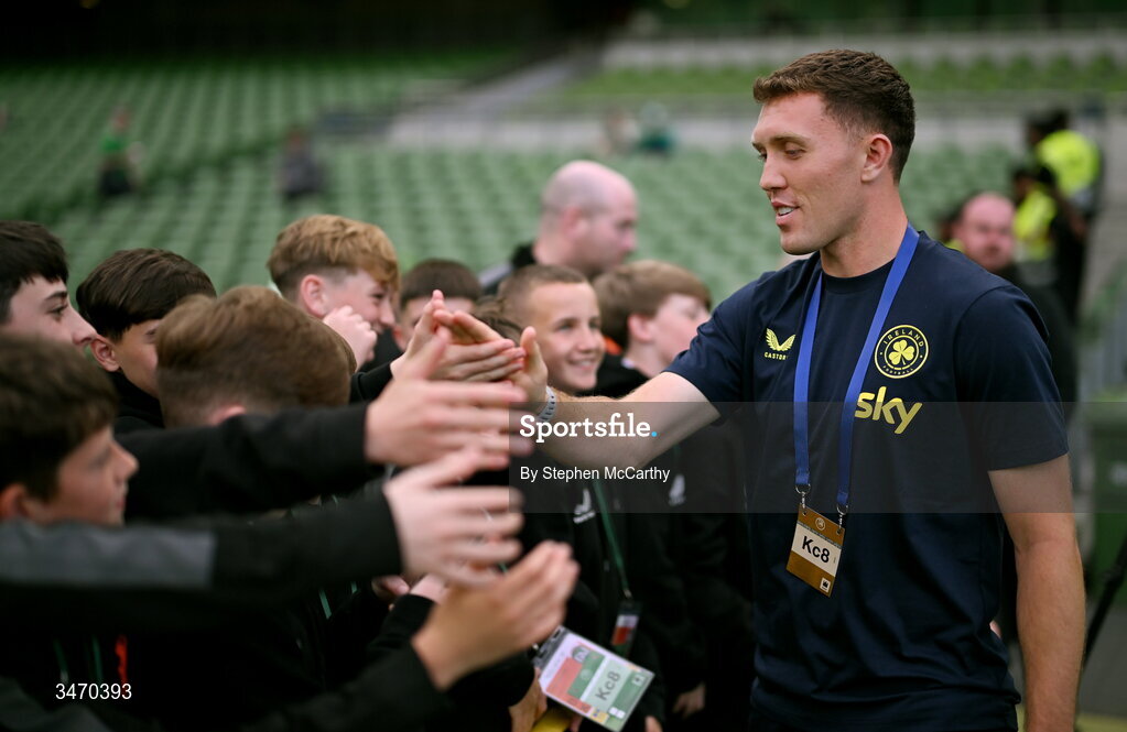 28 May 2026; Dara O'Shea of Republic of Ireland with ball boys from St Kevin's FC before the international friendly match between Republic of Ireland and Qatar at the Aviva Stadium in Dublin. Photo by Stephen McCarthy/Sportsfile