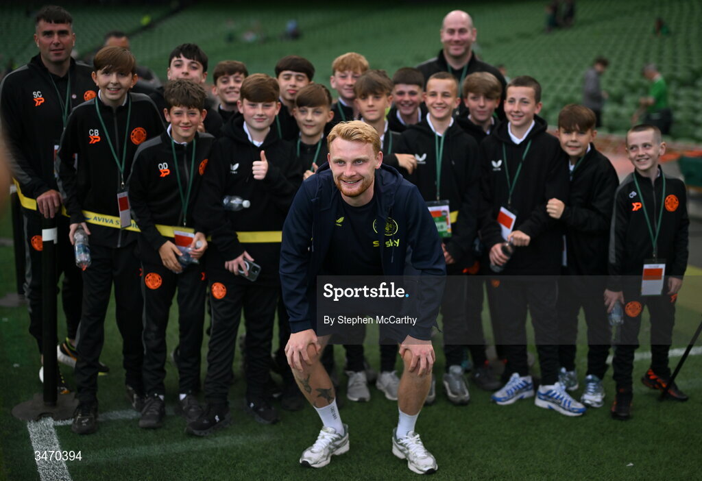 28 May 2026; Liam Scales of Republic of Ireland with ball boys from St Kevin's FC before the international friendly match between Republic of Ireland and Qatar at the Aviva Stadium in Dublin. Photo by Stephen McCarthy/Sportsfile