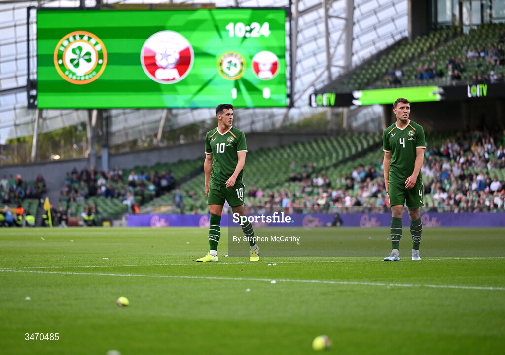 28 May 2026; Republic of Ireland players Jamie McGrath, left, and Dara O'Shea as tennis balls are thrown onto the pitch during the international friendly match between Republic of Ireland and Qatar at the Aviva Stadium in Dublin. Photo by Stephen McCarthy/Sportsfile