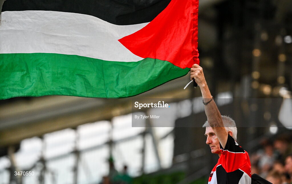 28 May 2026; A supporter waves the flag of Palestine during the international friendly match between Republic of Ireland and Qatar at the Aviva Stadium in Dublin. Photo by Tyler Miller/Sportsfile