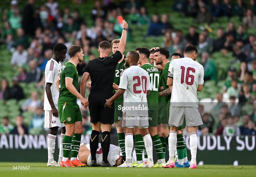 28 May 2026; Referee Jamie Robinson shows a red card to Jack Moylan of Republic of Ireland, hidden, during the international friendly match between Republic of Ireland and Qatar at the Aviva Stadium in Dublin. Photo by Stephen McCarthy/Sportsfile