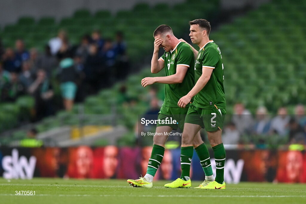 28 May 2026; Jack Moylan of Republic of Ireland, left, is consoled by teammate Seamus Coleman as he leaves the pitch after being shown a red card during the international friendly match between Republic of Ireland and Qatar at the Aviva Stadium in Dublin. Photo by Stephen McCarthy/Sportsfile