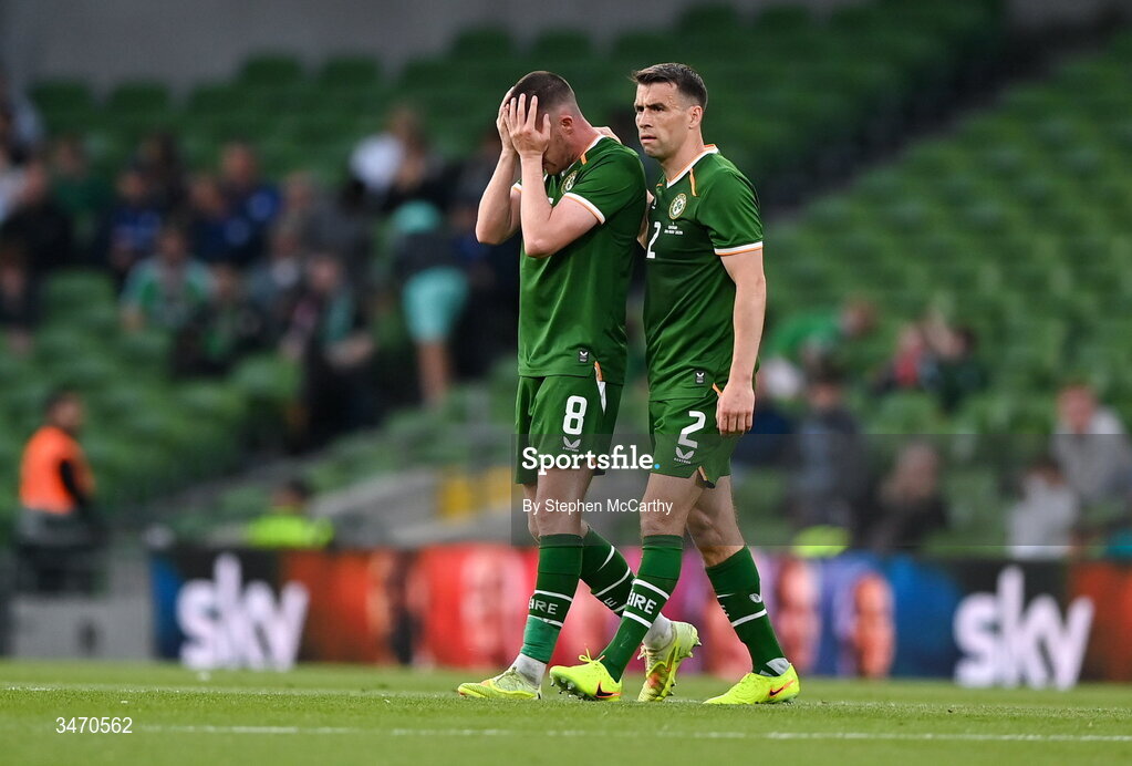 28 May 2026; Jack Moylan of Republic of Ireland, left, is consoled by teammate Seamus Coleman as he leaves the pitch after being shown a red card during the international friendly match between Republic of Ireland and Qatar at the Aviva Stadium in Dublin. Photo by Stephen McCarthy/Sportsfile