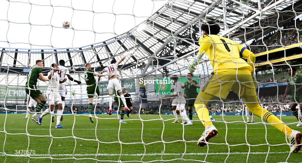 28 May 2026; Nathan Collins of Republic of Ireland scores his side's first goal, past Qatar goalkeeper Mahmoud Abunada, during the international friendly match between Republic of Ireland and Qatar at the Aviva Stadium in Dublin. Photo by Stephen McCarthy/Sportsfile