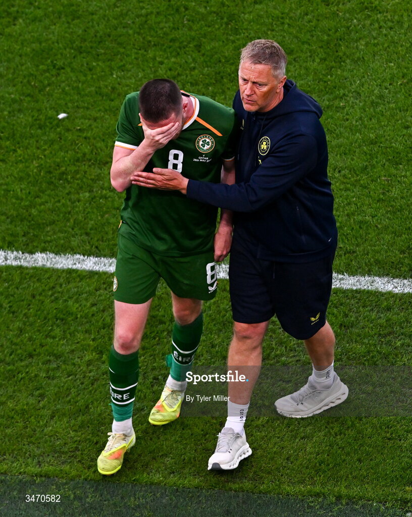 28 May 2026; Jack Moylan of Republic of Ireland is consoled by manager Heimir Hallgrimsson as he leaves the pitch after being shown a red card during the international friendly match between Republic of Ireland and Qatar at the Aviva Stadium in Dublin. Photo by Tyler Miller/Sportsfile