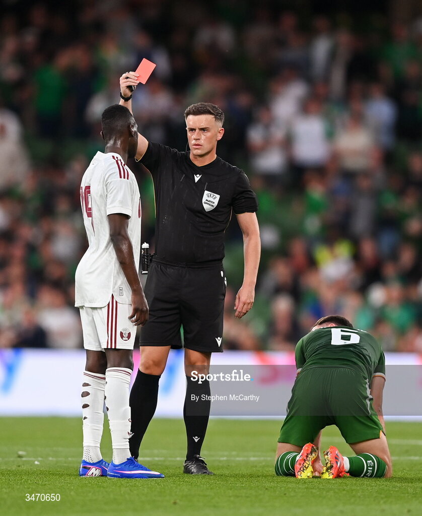 28 May 2026; Referee Jamie Robinson shows a red card to Almoez Ali of Qatar during the international friendly match between Republic of Ireland and Qatar at the Aviva Stadium in Dublin. Photo by Stephen McCarthy/Sportsfile