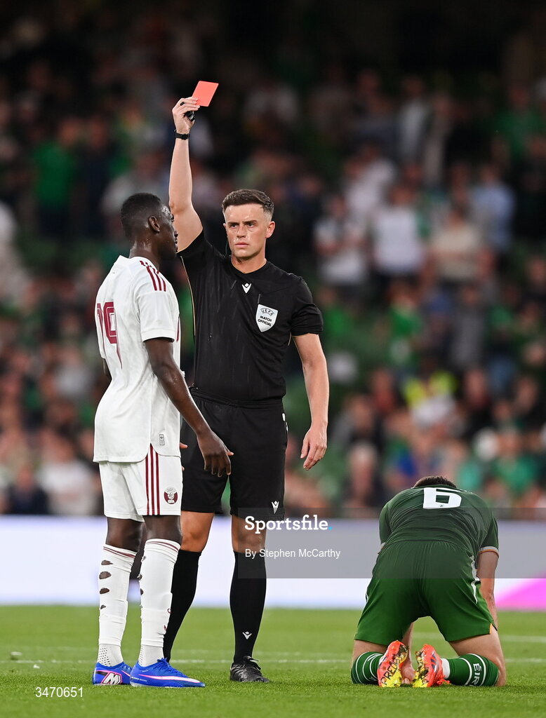 28 May 2026; Referee Jamie Robinson shows a red card to Almoez Ali of Qatar during the international friendly match between Republic of Ireland and Qatar at the Aviva Stadium in Dublin. Photo by Stephen McCarthy/Sportsfile