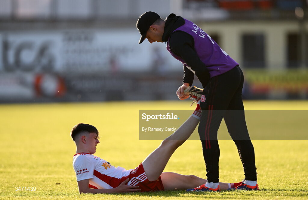 29 May 2026; Conan Canavan of Tyrone is treated for cramp by Tyrone coach Niall Morgan during the Electric Ireland Ulster GAA Football Minor Championship final match between Derry and Tyrone at O'Donnell Park in Letterkenny, Donegal. Photo by Ramsey Cardy/Sportsfile