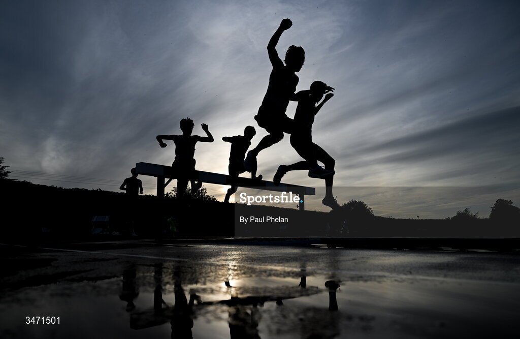 29 May 2026; Athletes, silhoutted against the sky, competing in the senior boys 2000m steeplechase during day one of the 123.ie All-Ireland Schools' Track and Field Championships at Tullamore Harriers Athletics Club in Offaly. Photo by Paul Phelan/Sportsfile