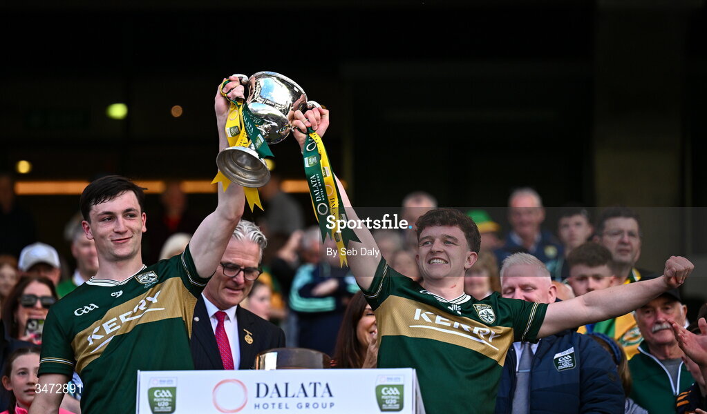 30 May 2026; Kerry players Ronan Carroll, left, and Gearóid White lift the Clarke Cup after their side's victory in the Dalata Hotels Group GAA Football All-Ireland U20 Championship final match between Kerry and Tyrone at Croke Park in Dublin. Photo by Seb Daly/Sportsfile