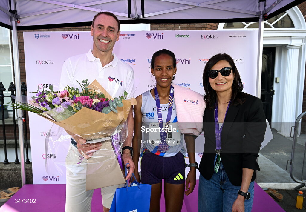 31 May 2026; Winner Chaltu Dida with Brian Walsh, Vhi, left, and Cynthia O’Neil, DSD AC Chairperson, during the 2026 Vhi Women’s Mini Marathon. Almost 30,000 women from all over the country took to the streets of Dublin to run, walk and jog the 10km route, raising much needed funds for hundreds of charities around the country. www.vhiwomensminimarathon.ie. Photo by Ramsey Cardy/Sportsfile