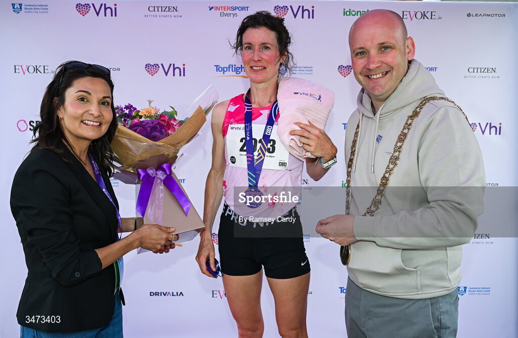 31 May 2026; Second place finisher Sorcha Nic Dhomhnaill of Limerick Country Club AC, with Lord Mayor of Dublin, Councillor Ray McAdam, right, and Cynthia O’Neil, DSD AC Chairperson, during the 2026 Vhi Women’s Mini Marathon. Almost 30,000 women from all over the country took to the streets of Dublin to run, walk and jog the 10km route, raising much needed funds for hundreds of charities around the country. www.vhiwomensminimarathon.ie. Photo by Ramsey Cardy/Sportsfile