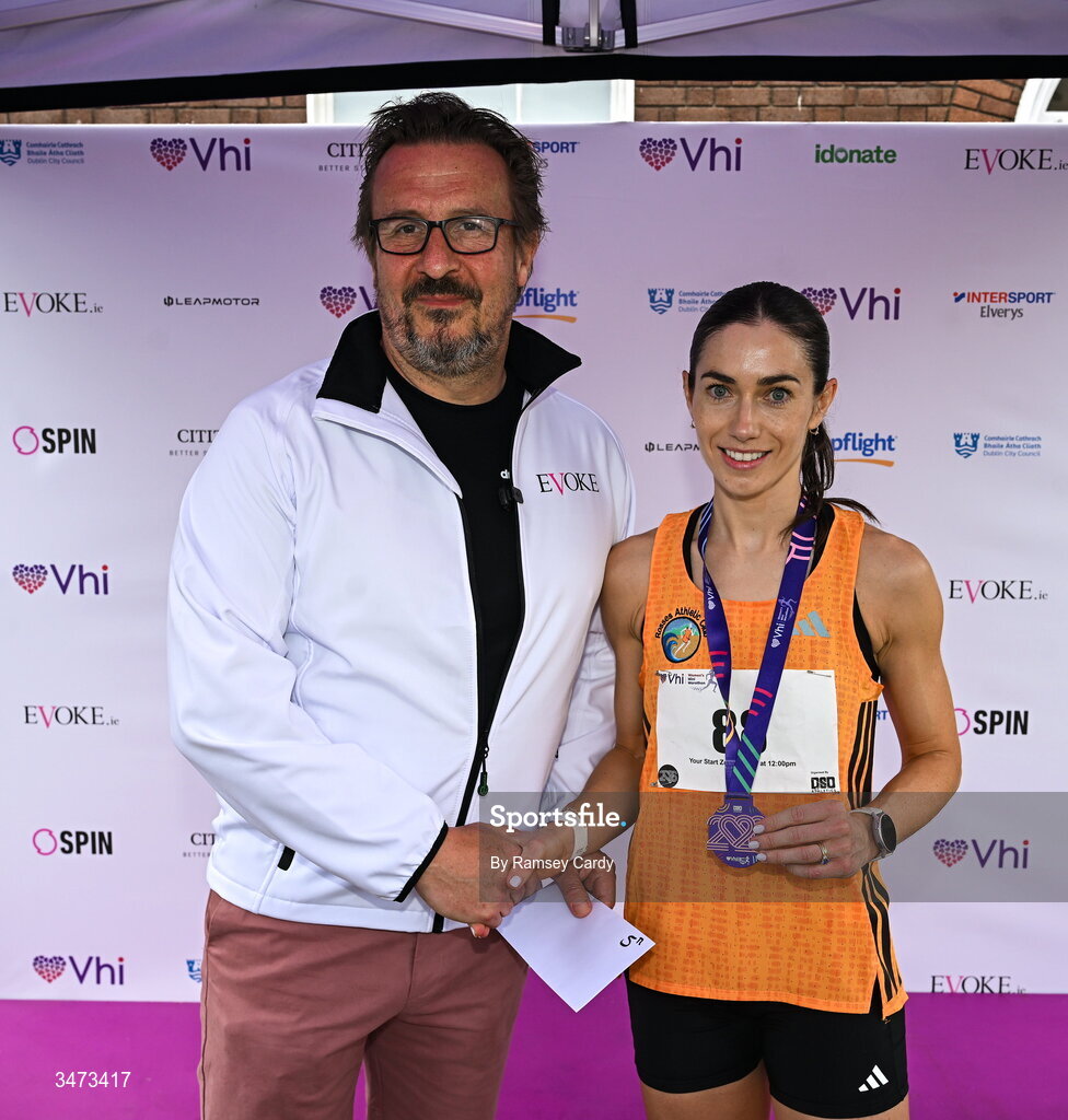 31 May 2026; Fifth place finisher Maria McGee of Rosses AC with Fintan Gavigan, dmg media, during the 2026 Vhi Women’s Mini Marathon. Almost 30,000 women from all over the country took to the streets of Dublin to run, walk and jog the 10km route, raising much needed funds for hundreds of charities around the country. www.vhiwomensminimarathon.ie. Photo by Ramsey Cardy/Sportsfile