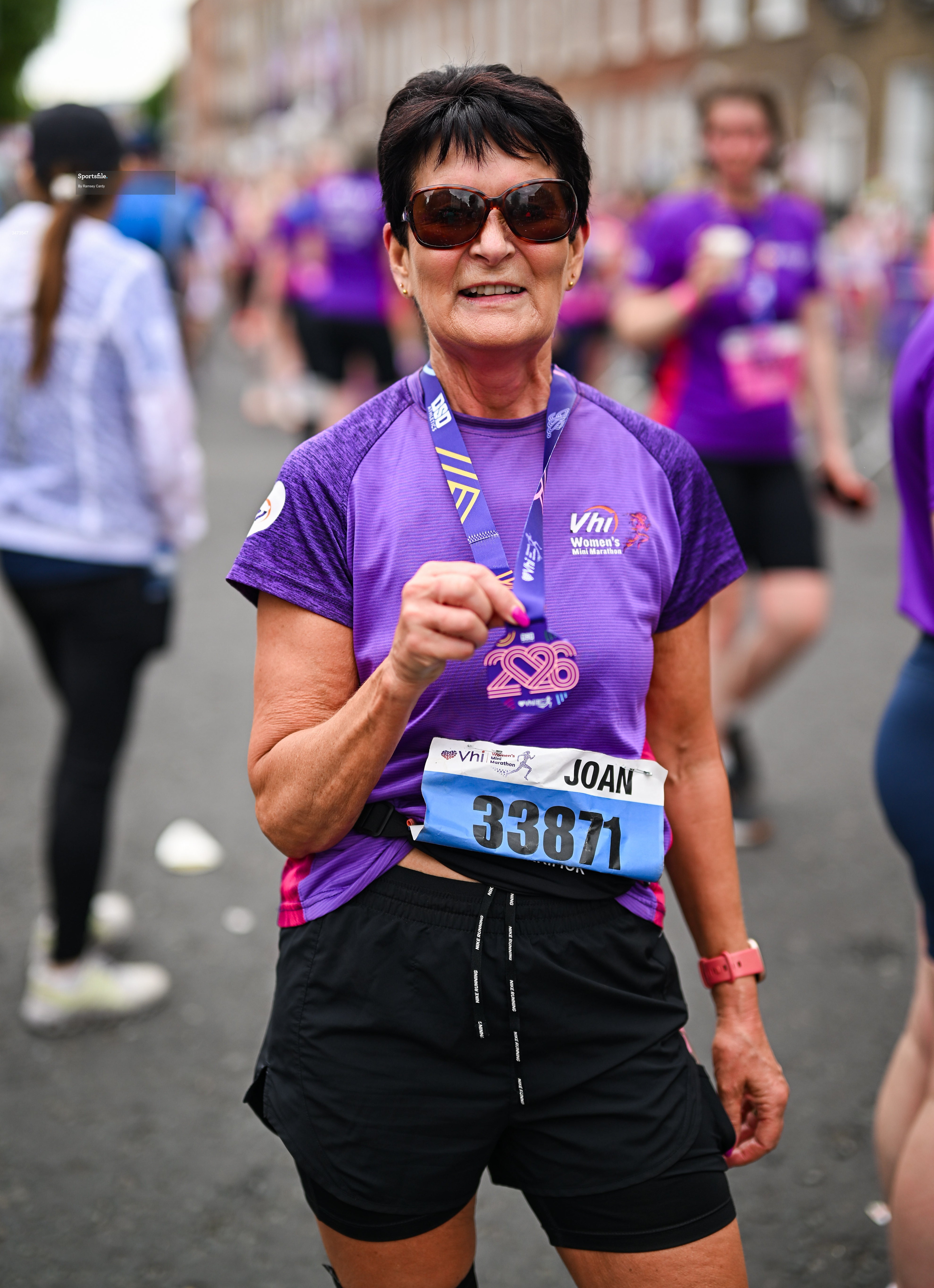 31 May 2026; Joan McCoy with her medal after the 2026 Vhi Women’s Mini Marathon. Almost 30,000 women from all over the country took to the streets of Dublin to run, walk and jog the 10km route, raising much needed funds for hundreds of charities around the country. www.vhiwomensminimarathon.ie. Photo by Ramsey Cardy/Sportsfile