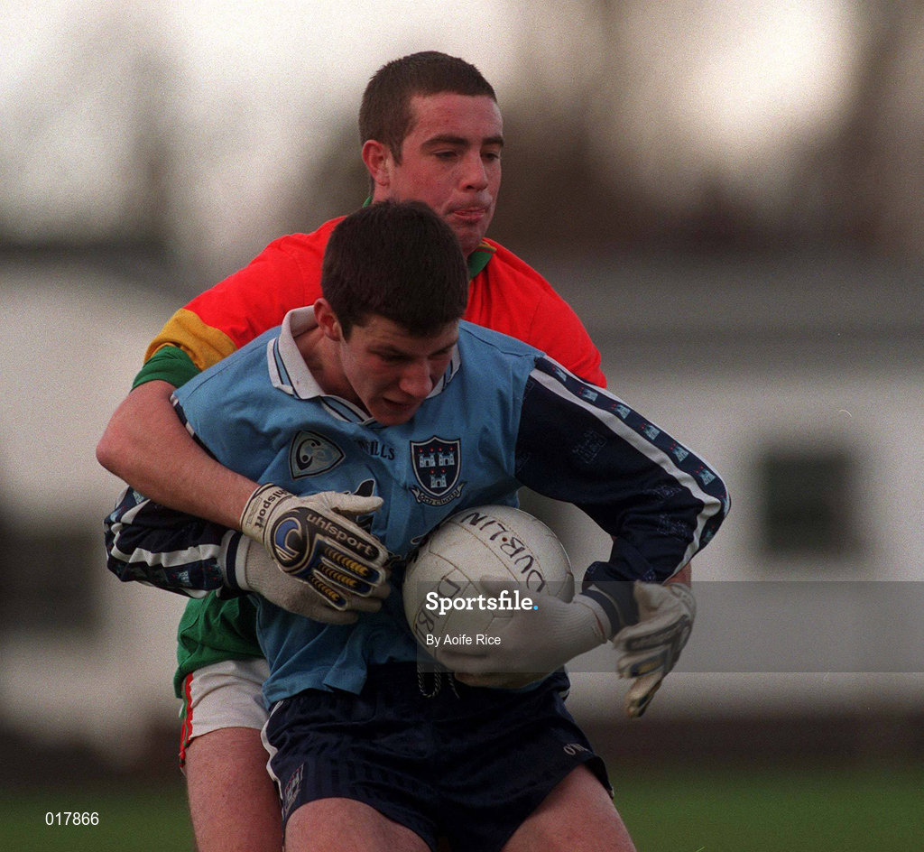 16 January 1999; Colm Moran of Dublin is tackled by Joe Byrne of Carlow during the O'Byrne Cup Quarter-Final match between Carlow and Dublin at Dr Cullen Park in Carlow. Photo by Aoife Rice/Sportsfile