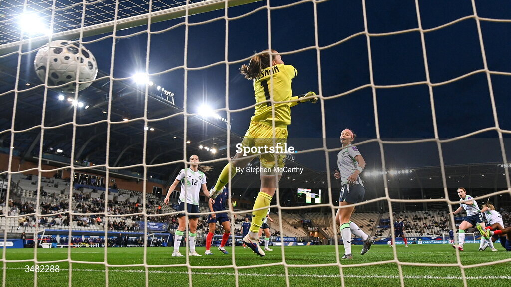 9 June 2026; Melvine Malard of France, not pictured, shoots to score her side's first goal as Republic of Ireland goalkeeper Courtney Brosnan attempts to make a save during the 2027 FIFA Women’s World Cup Qualifier match between France and Republic of Ireland at Stade des Alpes in Grenoble, France. Photo by Stephen McCarthy/Sportsfile