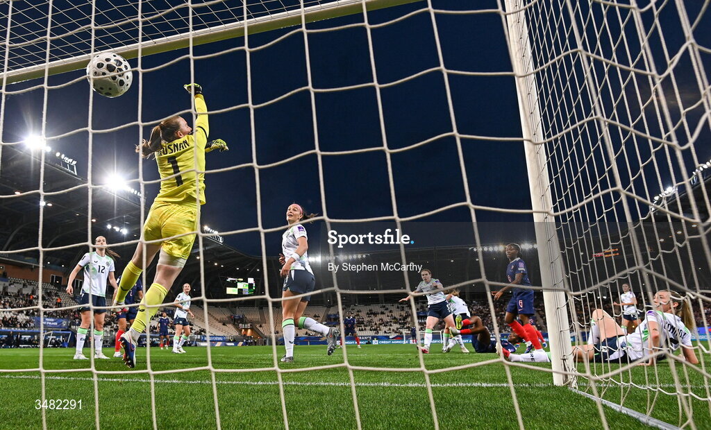 9 June 2026; Melvine Malard of France, hidden, shoots to score her side's first goal as Republic of Ireland goalkeeper Courtney Brosnan attempts to make a save during the 2027 FIFA Women’s World Cup Qualifier match between France and Republic of Ireland at Stade des Alpes in Grenoble, France. Photo by Stephen McCarthy/Sportsfile