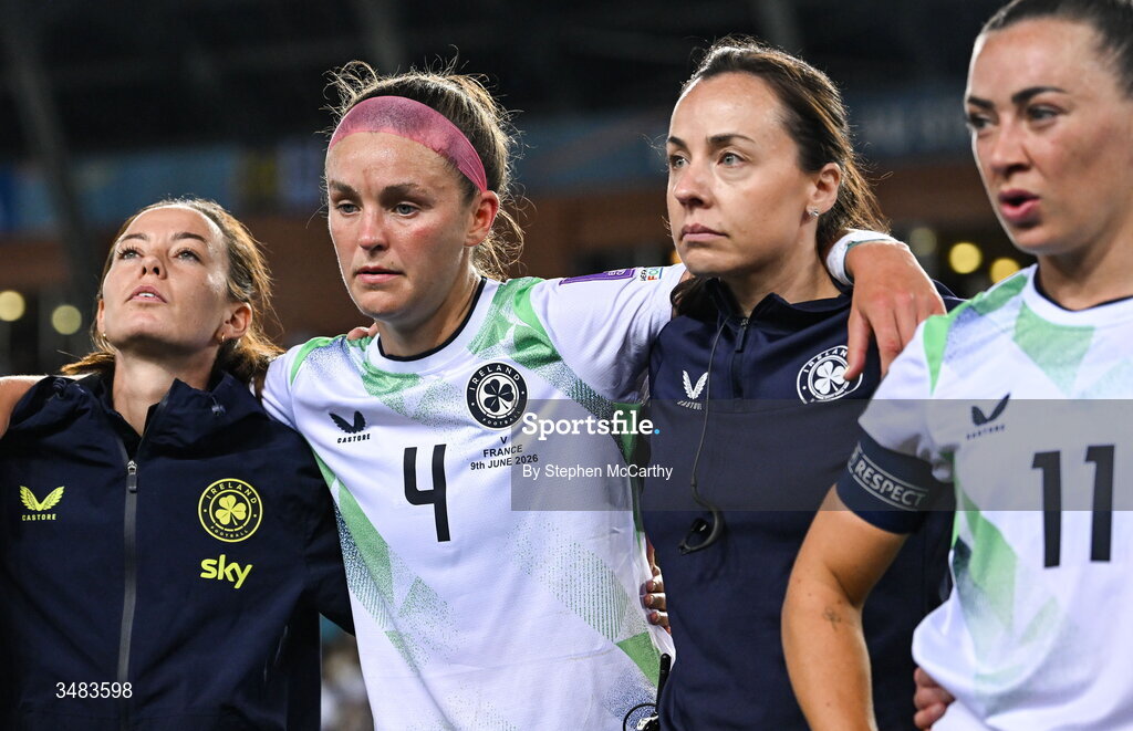 9 June 2026; Republic of Ireland players and staff, from left, assistant coach Amber Whiteley, Caitlin Hayes, lead physiotherapist Angela Kenneally and Katie McCabe following their side's defeat in the 2027 FIFA Women’s World Cup Qualifier match between France and Republic of Ireland at Stade des Alpes in Grenoble, France. Photo by Stephen McCarthy/Sportsfile