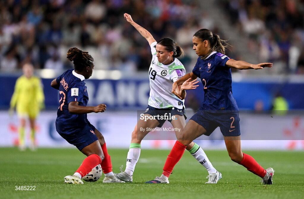 9 June 2026; Abbie Larkin of Republic of Ireland in action against Sandy Baltimore, left, and Maelle Lakrar of France during the 2027 FIFA Women’s World Cup Qualifier match between France and Republic of Ireland at Stade des Alpes in Grenoble, France. Photo by Stephen McCarthy/Sportsfile
