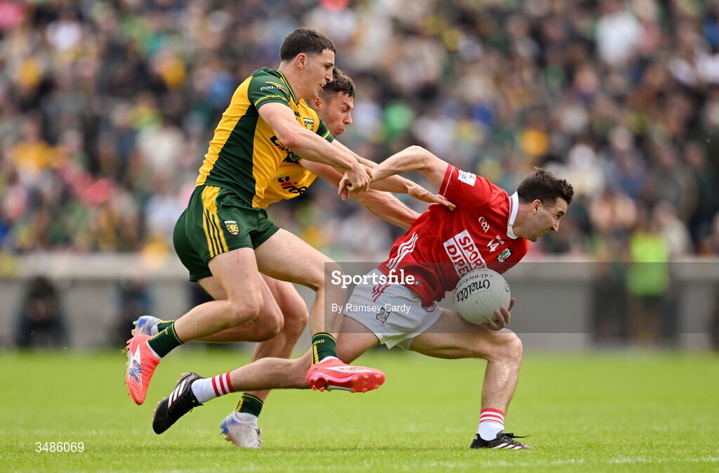 13 June 2026; Chris Óg Jones of Cork in action against Finnbarr Roarty, left, and Conor O'Donnell of Donegal during the GAA Football All-Ireland Senior Championship Round 2A match between Donegal and Cork at MacCumhaill Park in Ballybofey, Donegal. Photo by Ramsey Cardy/Sportsfile
