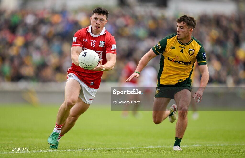 13 June 2026; Mark Cronin of Cork in action against Peadar Mogan of Donegal during the GAA Football All-Ireland Senior Championship Round 2A match between Donegal and Cork at MacCumhaill Park in Ballybofey, Donegal. Photo by Ramsey Cardy/Sportsfile