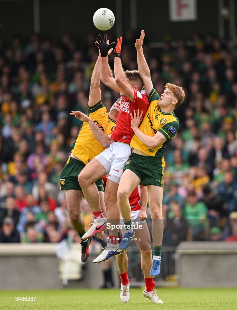 13 June 2026; Ian Maguire of Cork in action against Caolan McGonagle, left, and Ciaran Moore of Donegal during the GAA Football All-Ireland Senior Championship Round 2A match between Donegal and Cork at MacCumhaill Park in Ballybofey, Donegal. Photo by Ramsey Cardy/Sportsfile