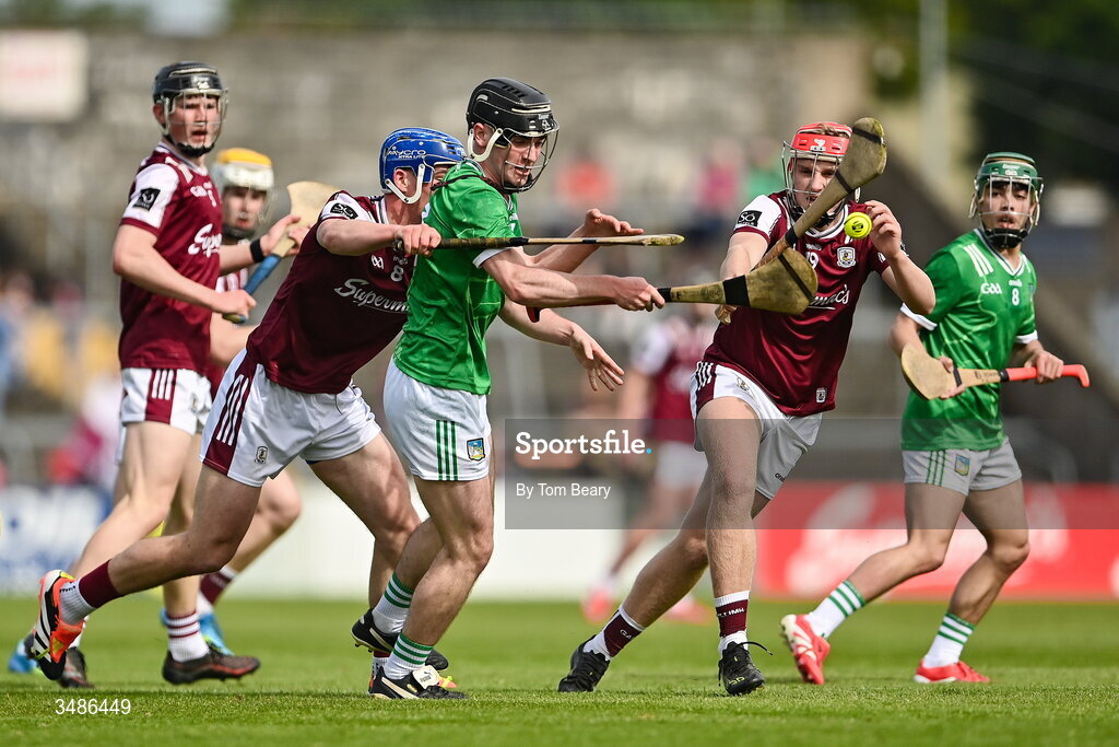 13 June 2026; Eoin Hennessy of Limerick is tackled by Gus Lohan, left, and Eli Huban of Galway during the Electric Ireland All-Ireland Minor Hurling Championship semi-final match between Galway and Limerick at Zimmer Biomet Páirc Chíosóg in Ennis, Clare. Photo by Tom Beary/Sportsfile