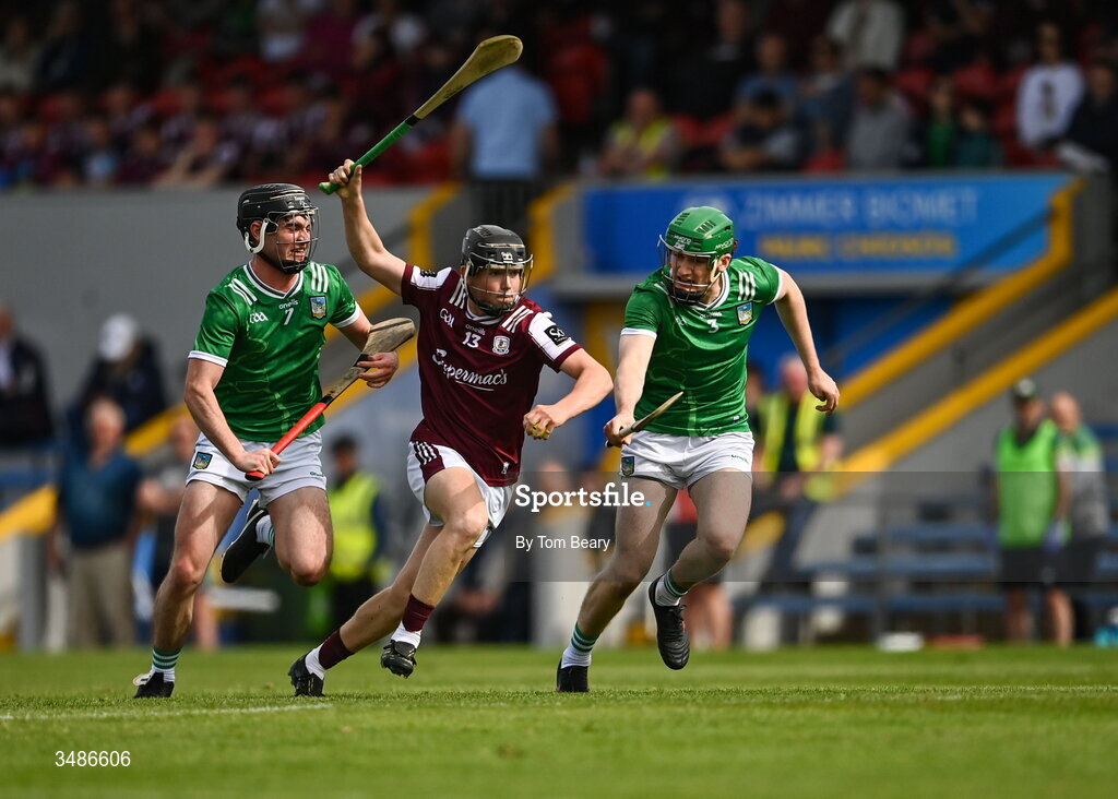13 June 2026; Michael Coen of Galway is tackled by Eoin Hennessy, left and William Ryan of Limerick during the Electric Ireland All-Ireland Minor Hurling Championship semi-final match between Galway and Limerick at Zimmer Biomet Páirc Chíosóg in Ennis, Clare. Photo by Tom Beary/Sportsfile