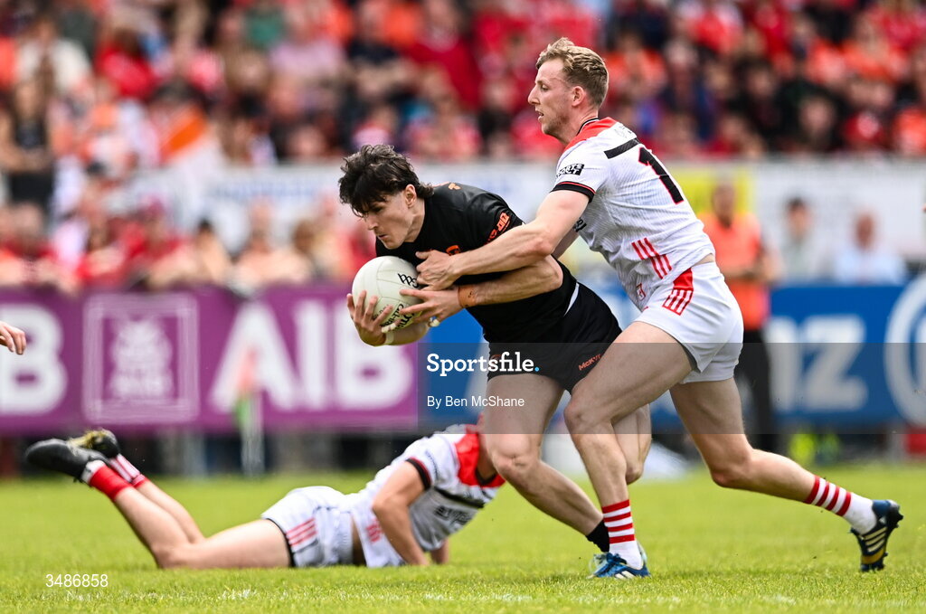 14 June 2026; Tiernan Kelly of Armagh is tackled by Paul Matthews of Louth during the GAA Football All-Ireland Senior Championship Round 2A match between Louth and Armagh at Páirc Grattan in Inniskeen, Monaghan. Photo by Ben McShane/Sportsfile