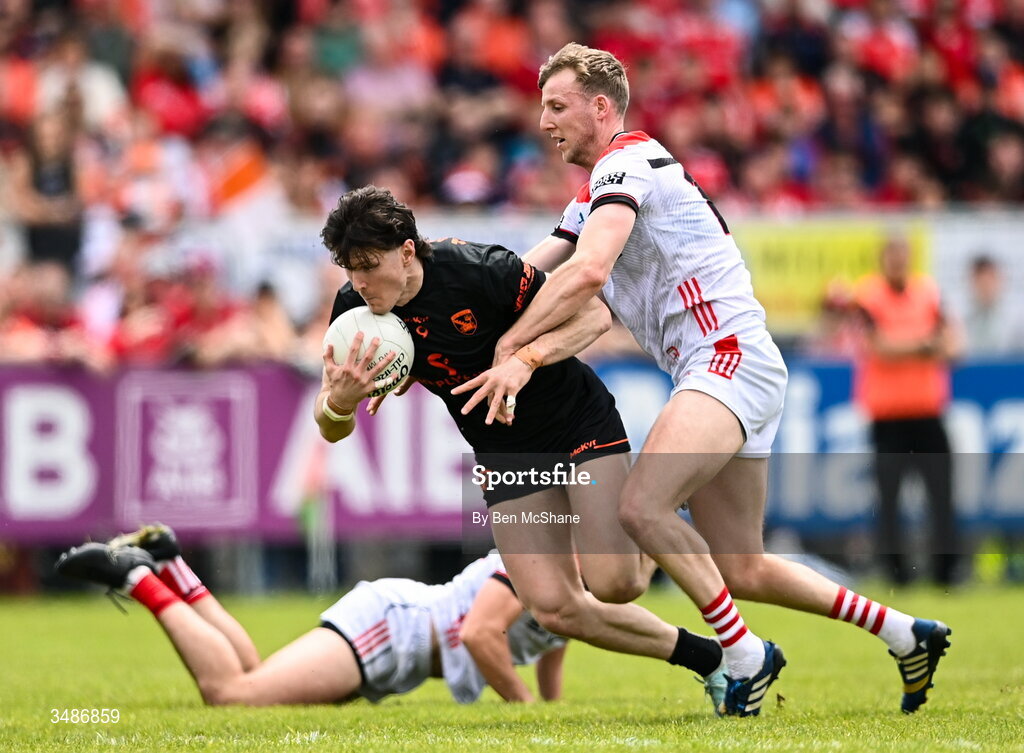 14 June 2026; Tiernan Kelly of Armagh is tackled by Paul Matthews of Louth during the GAA Football All-Ireland Senior Championship Round 2A match between Louth and Armagh at Páirc Grattan in Inniskeen, Monaghan. Photo by Ben McShane/Sportsfile