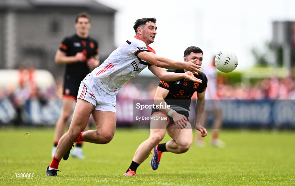 14 June 2026; Emmet Carolan of Louth in action against Oisin Conaty of Armagh during the GAA Football All-Ireland Senior Championship Round 2A match between Louth and Armagh at Páirc Grattan in Inniskeen, Monaghan. Photo by Ben McShane/Sportsfile