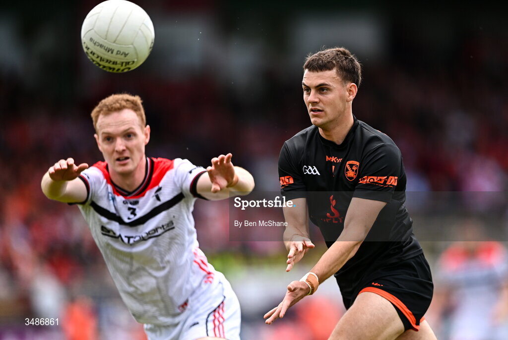 14 June 2026; Darragh McMullan of Armagh gets a pass away despite the attention of Donal McKenny of Louth during the GAA Football All-Ireland Senior Championship Round 2A match between Louth and Armagh at Páirc Grattan in Inniskeen, Monaghan. Photo by Ben McShane/Sportsfile
