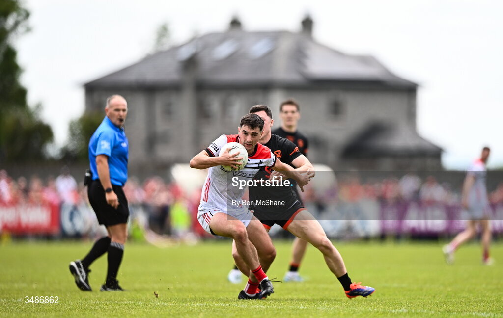 14 June 2026; Emmet Carolan of Louth in action against Oisin Conaty of Armagh during the GAA Football All-Ireland Senior Championship Round 2A match between Louth and Armagh at Páirc Grattan in Inniskeen, Monaghan. Photo by Ben McShane/Sportsfile
