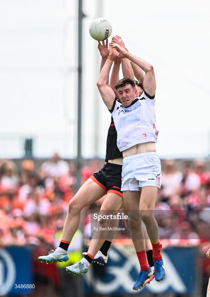 14 June 2026; Dara McDonnell of Louth contests possession against Armagh players Tiernan Kelly and Jarly Og Burns during the GAA Football All-Ireland Senior Championship Round 2A match between Louth and Armagh at Páirc Grattan in Inniskeen, Monaghan. Photo by Ben McShane/Sportsfile