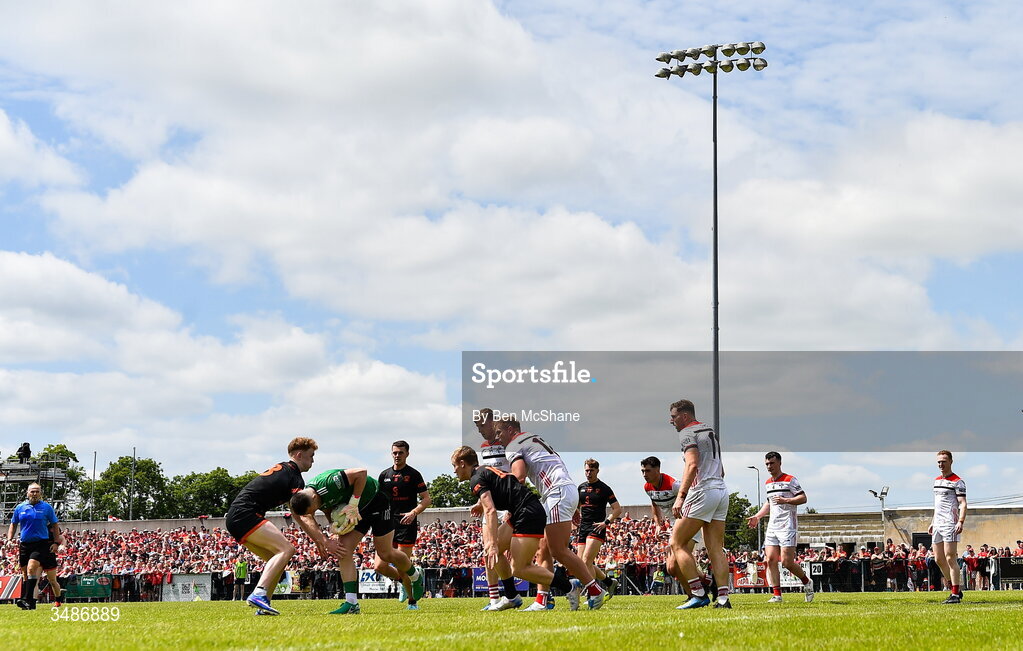 14 June 2026; Louth goalkeeper Niall McDonnell under pressure from Conor Turbitt of Armagh during the GAA Football All-Ireland Senior Championship Round 2A match between Louth and Armagh at Páirc Grattan in Inniskeen, Monaghan. Photo by Ben McShane/Sportsfile