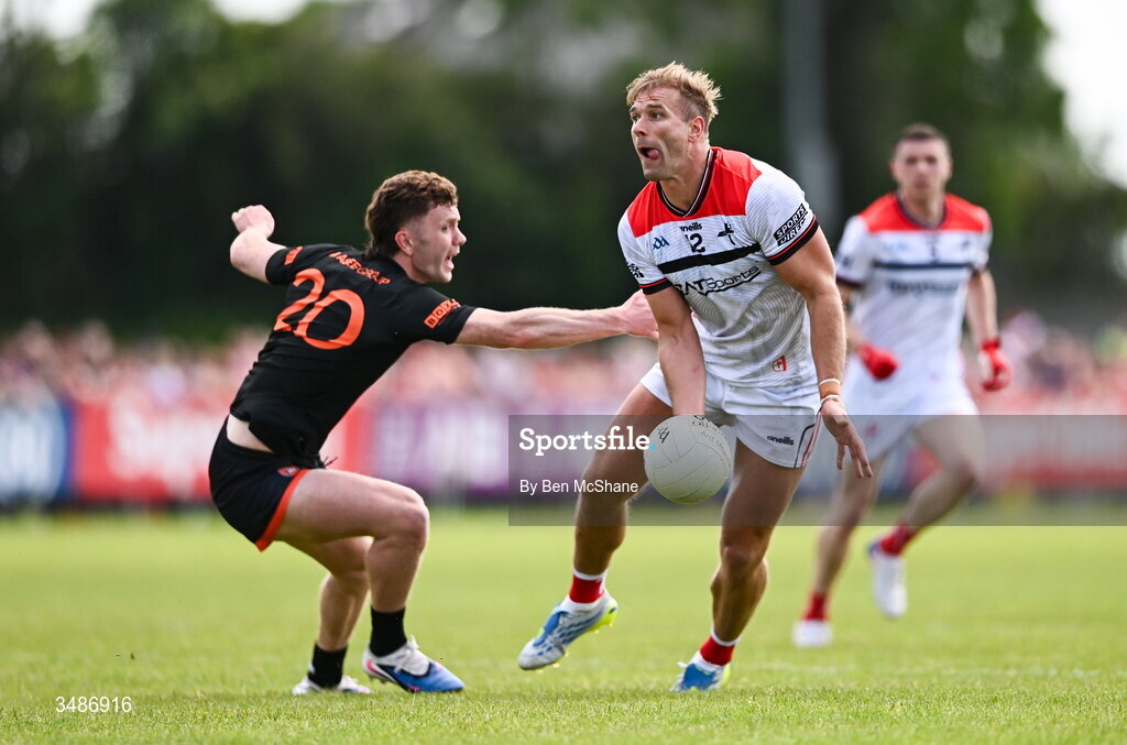 14 June 2026; Conor Grimes of Louth in action against Ross McQuillan of Armagh during the GAA Football All-Ireland Senior Championship Round 2A match between Louth and Armagh at Páirc Grattan in Inniskeen, Monaghan. Photo by Ben McShane/Sportsfile
