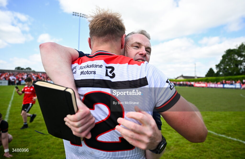 14 June 2026; Louth manager Gavin Devlin celebrates with Conor Grimes of Louth after the GAA Football All-Ireland Senior Championship Round 2A match between Louth and Armagh at Páirc Grattan in Inniskeen, Monaghan. Photo by Ben McShane/Sportsfile