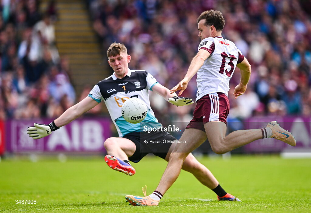 14 June 2026; Robert Finnerty of Galway scores a point under pressure from Westmeath goalkeeper Jason Daly during the GAA Football All-Ireland Senior Championship Round 2A match between Galway and Westmeath at Pearse Stadium in Salthill, Galway. Photo by Piaras Ó Mídheach/Sportsfile