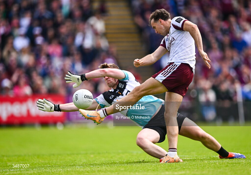 14 June 2026; Robert Finnerty of Galway scores a point under pressure from Westmeath goalkeeper Jason Daly during the GAA Football All-Ireland Senior Championship Round 2A match between Galway and Westmeath at Pearse Stadium in Salthill, Galway. Photo by Piaras Ó Mídheach/Sportsfile