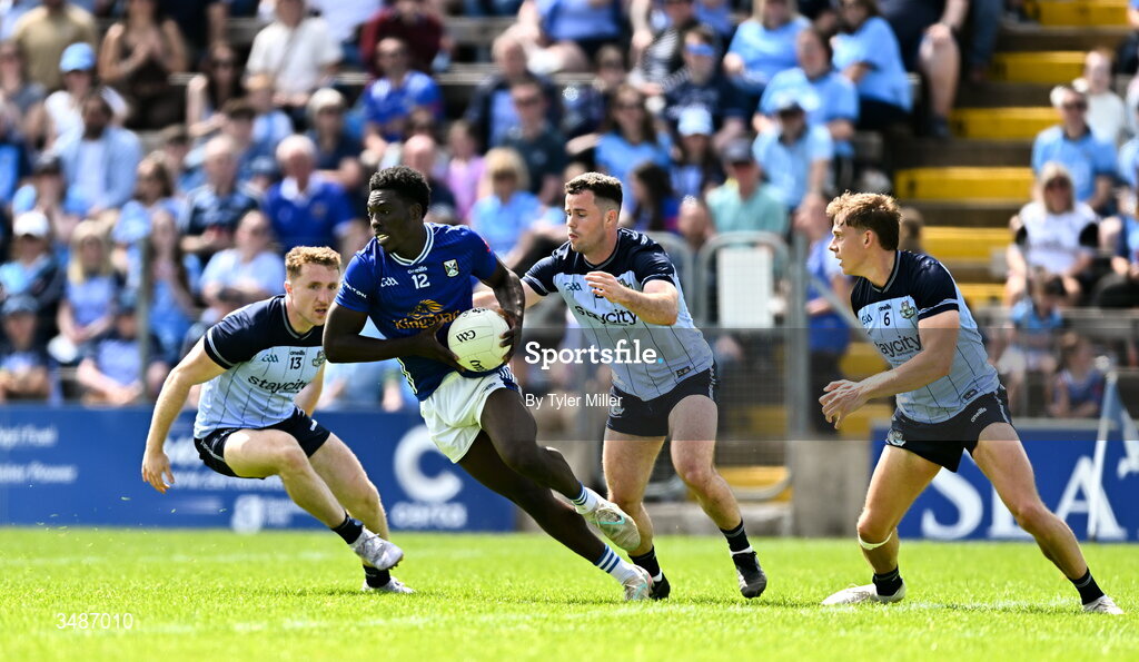 14 June 2026; Emmanuel Shehu of Cavan in action against Dublin players, from left, Paddy Small, Ross McGarry and Charlie McMorrow during the GAA Football All-Ireland Senior Championship Round 2B match between Cavan and Dublin at Kingspan Breffni in Cavan. Photo by Tyler Miller/Sportsfile
