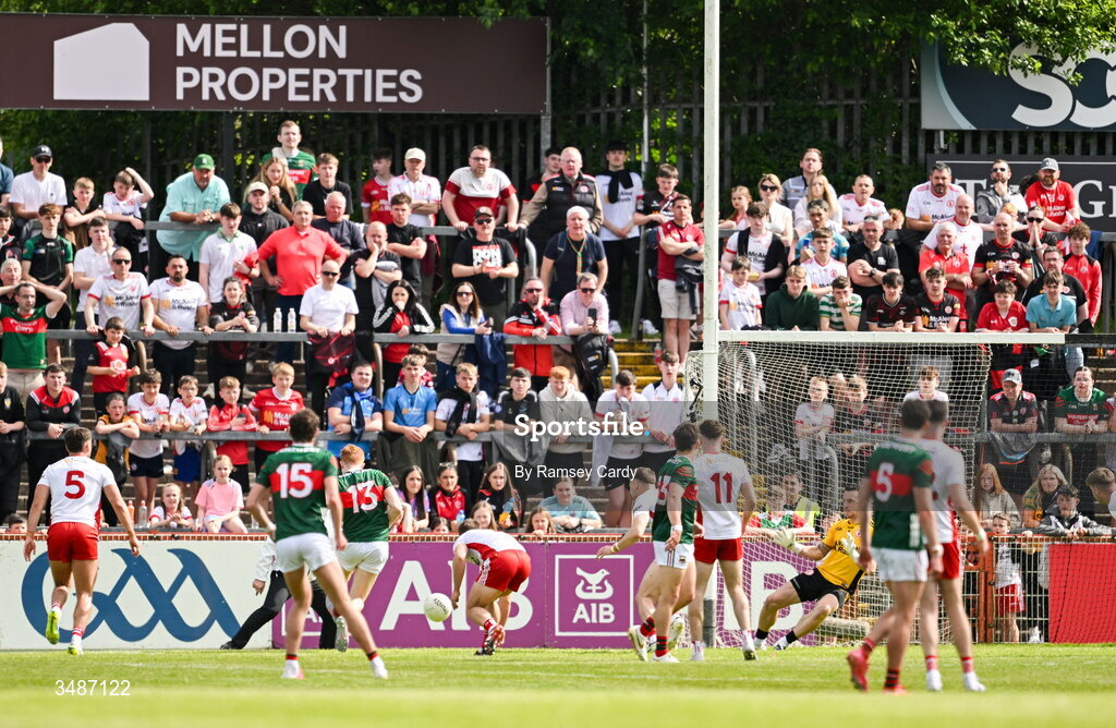 14 June 2026; Darragh Beirne of Mayo, 13, shoots to score his side's first goal past Tyrone goalkeeper Niall Morgan during the GAA Football All-Ireland Senior Championship Round 2A match between Tyrone and Mayo at O’Neills Healy Park in Omagh, Tyrone. Photo by Ramsey Cardy/Sportsfile